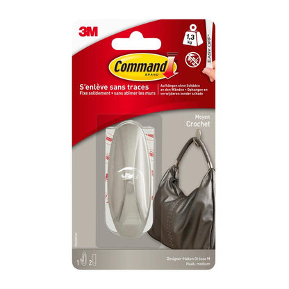Command™ Medium Designer Hook -pakkaus metallisessa ulkonäössä (17081BN) 3M Deutschland GmbH:ltä näyttää tukevan koukun, joka pitää käsilaukkua. Pakkauksen mukaan se kestää jopa 1,3 kg ja voidaan puhdistaa jälkiä jättämättä.