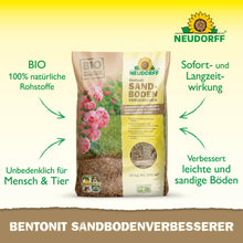 10 kg:n säkki Neudorff Shop Bentonit SandbodenVerbesserer seisoo pystyasennossa vaalealla pinnalla. Pakkauksessa on vaaleanpunaisia ruusuja ja tuotetietoja, jotka korostavat savimineraaleja ravinteiden varastointiin ja hiekkamaan parantamiseen.