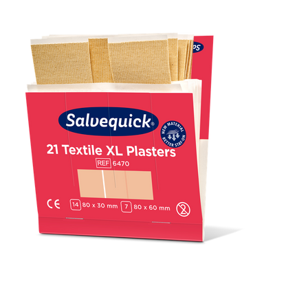 Eine rosa-weiße Schachtel von Orkla Wound Care AB mit der Aufschrift "Xl textilgips, 21 Stück/mine | Packung (6 Stück)" enthält große Gewebepflaster in zwei Größen: 80x30 mm und 80x60 mm. Oben auf der offenen Schachtel sind mehrere beigefarbene Pflaster zu sehen.