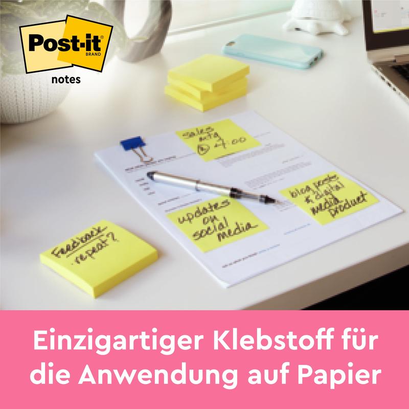 Pino 3M Post-it® Notes, keltainen (76 mm x 127 mm, 100 arkkia/lohko), sijaitsee työpöydällä muistiinpanojen vieressä. Teksti alhaalla: "Vahva liima - kiinnittyy varmasti paperiin. 12 lohkoa per pakkaus, kartonkipakkaus, 100% PEFC.
