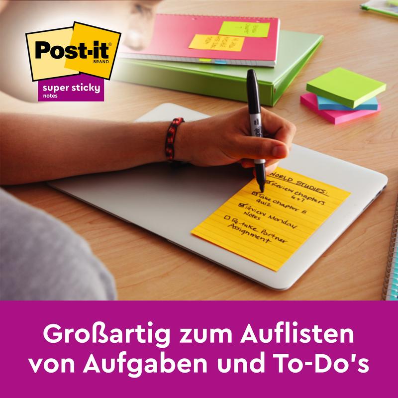 Käsi kirjoittaa keltaiselle Post-it® Notes -muistilapulle suurikokoisena (101 mm x 152 mm) 3M Deutschland GmbH:lta kannettavalla tietokoneella, ympärillä muita Post-it Notes -muistilappuja, kynä, muistikirja ja kansio. Täydellinen tehtävien ja To-Do-listojen luettelointiin.