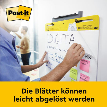 Käyttäjä kirjoittaa 3M Deutschland GmbH:n Post-it® Super Sticky itseliimautuvaan kokous-/fläppitauluun (58,4 x 50,8 cm), johon on kiinnitetty useita muistilappuja. Alapuolella lukee: "Arkit voidaan helposti irrottaa."