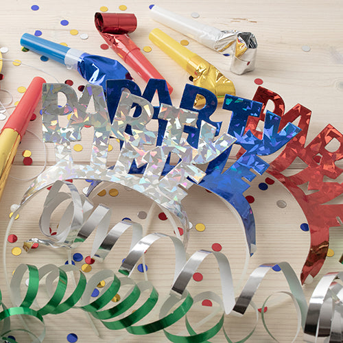 4 hiuspantaa värilajitelma "Metallinhohto" PAPSTAR GmbH:ltä loistavat kirkkaissa metalliväreissä, kuten sininen, punainen ja hopea – ihanteellinen juhliin, joissa on konfettia, aaltoilevia nauhoja ja värikkäitä melunaiheuttajia vaalealla puualustalla.