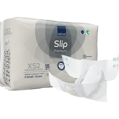 ABENA Slip Premium -pakkaus Abena Re-Seller GmbH:ltä, koko X-Small, jossa on 32 virtsankarkailusuojaliinaa. Edessä on avattu slip, joka näyttää sen suunnittelun tehokkaaseen inkontinenssihuoltoon.