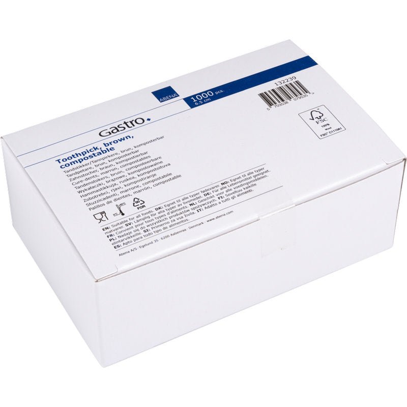 Valkoinen pahvilaatikko, jossa on teksti "Hammastikut, 65 mm, Pakkaamattomat, Puu | Paketti (1000 kpl)" Abena Re-Seller GmbH:lta, sisältäen tuotetiedot, symbolit ja viivakoodin sinivalkoisessa etiketissä.