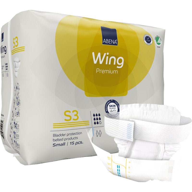 Pystyssä oleva pakkaus ABENA Wing Premium -vaippoja Abena Re-Seller GmbH:lta esitetään vyövaipan kanssa edessä. Pakkaus sisältää 15 pientä osaa, jotka tarjoavat suojaa ja mukavuutta luotettavaa rakonsuojaa varten.