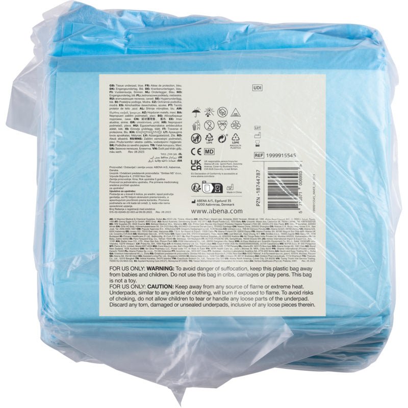 Läpinäkyvä muovipakkaus, jossa on 25 kappaletta Abena Re-Seller GmbH:n kertakäyttöistä alustaa, ABENA Tissue, 8-kerroksinen, 60x90 cm, sininen, näyttää etiketin hoitosymboleilla, ohjeilla ja monikielisillä varoituksilla.