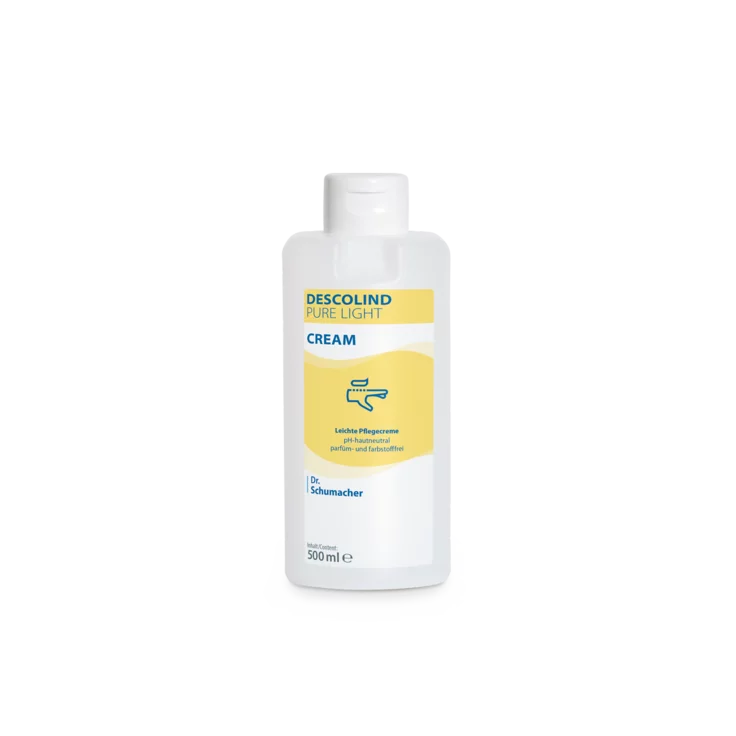 Valkoinen 500 ml:n muovipullo Dr. Schumacher GmbH Descolind Pure Light Cream -hoitovoidetta, hajusteeton herkälle iholle, jossa on keltainen etiketti ja sininen teksti, on kuvattu yksinkertaisella valkoisella taustalla.