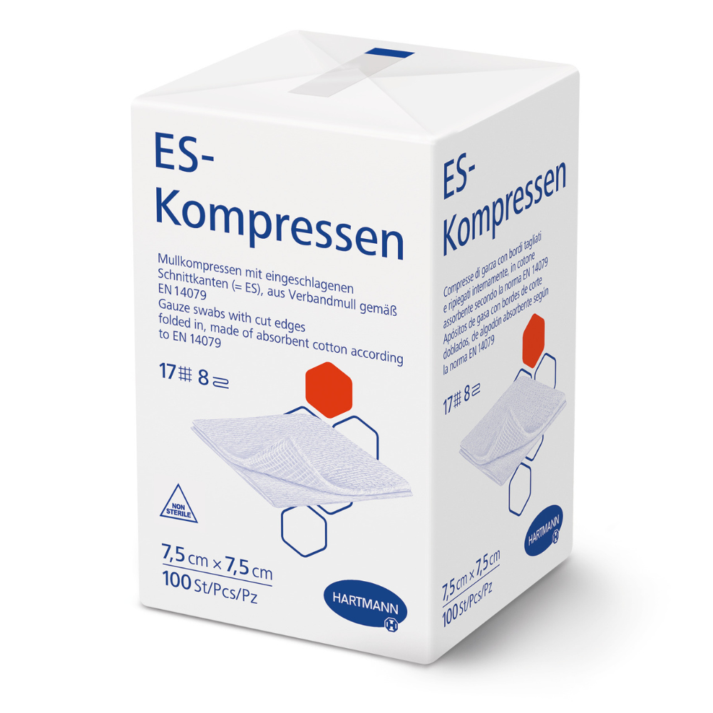 Valkoinen laatikko, jossa lukee "Hartmann ES-kompressiot eri kokoisina, steriloimattomat" Paul Hartmann AG:lta, esittää tuotetietoja saksaksi, mitat 7,5 x 7,5 cm, 100 kappaletta, kuva harsokompressioista haavanhoitoon ja Hartmann-logo alareunassa.
