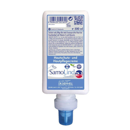 500 ml:n pullo SamoLind Sensitive 2in1 ihonsuoja- ja hoitovoide DR.SCHNELL GmbH & Co. KGaA:lta, sinisellä suuttimella ja etiketillä, jossa on saksankielisiä tuotetietoja.