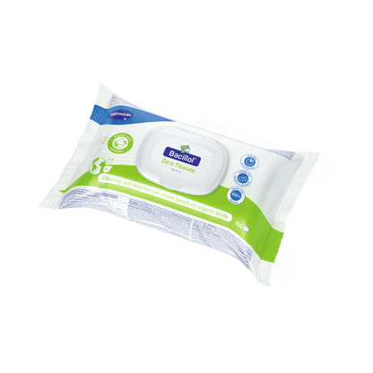 Pakkaus Hartmann Bacillola® Zero Tissues -pikadesinfiointipyyhkeitä Paul Hartmann AG:lta, kuvattuna valkoisella taustalla. Enimmäkseen valkoisena, sinisenä ja vihreänä suunniteltu pakkaus sisältää 100 muovitonta desinfiointipyyhettä.