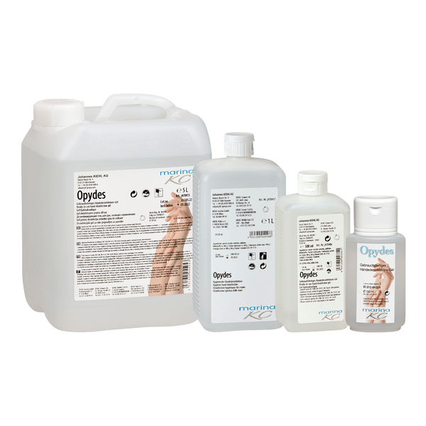 Kuvassa on neljä kirkasta pulloa Kiehl Opydes Hygienische Händedesinfektion Johannes Kiehl KG:ltä eri kokoisina rivissä. Niissä on valkoinen ja sininen teksti sekä käsisymbolit hygieniseen käsien desinfiointiin ja mikrobien vähentämiseen.