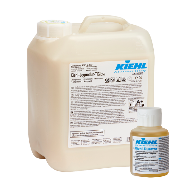 Eine 5L Johannes Kiehl KG Kiehl-Legnodur-TiGloss steht hinter einer 100ml Kiehl-Durator Flasche, beide mit detaillierten Etiketten für ihre selbstglänzende 2-Komponenten-Permanentbeschichtung für den Oberflächenschutz.