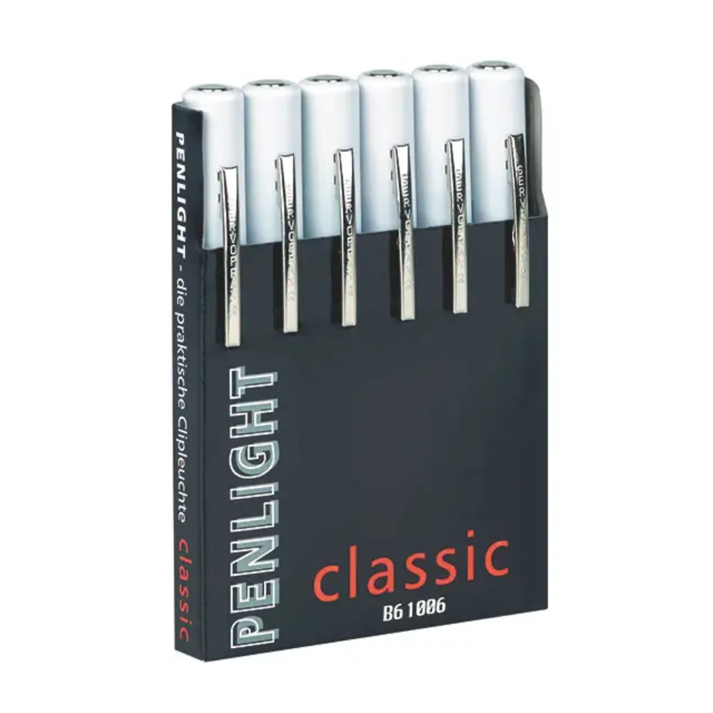 Musta laatikko, jossa on teksti „Penlight Classic Six Pack Dispenser, bedruckt“ Servoprax GmbH:lta, sisältää kuusi valkoista, kynänmuotoista taskulamppua, joita käytetään usein lääketieteellisissä tutkimuksissa. Jokaisessa kynälampussa on hopeinen kiinnike, joka mahdollistaa helpon pääsyn diagnoosin aikana.