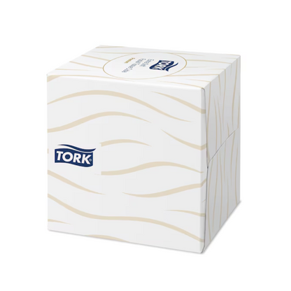 Valkoinen Tork 140278 Tork extra pehmeä nenäliina-annostelukuutio, jossa on aaltoileva beige kuvio ja TORK-logo sivussa.