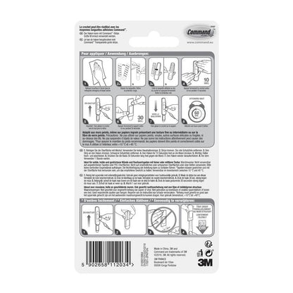 3M Deutschland GmbH:n Keskikokoisen Command™ monikäyttökoukun M edullispakkauksen (17001-2) takapuolella on kuvalliset asennusohjeet, monikieliset varoitukset, viivakoodi, valmistajatiedot ja 3M-logo alhaalla oikealla.