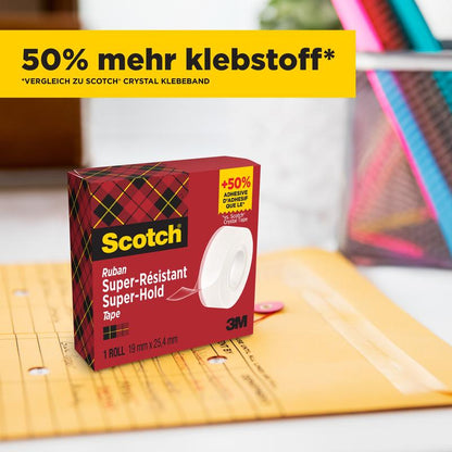 Yksi laatikko Scotch® Super-Hold Secure Tape -teippiä, 1 rulla, 19 mm x 25,4 m (3M Deutschland GmbH), punavihreässä ruutukuvioisessa pakkauksessa, makaa suljetun Manila-kirjekuoren vieressä. Keltainen banneri, jossa lukee "50 % enemmän liimaa*", on laatikon yläpuolella.