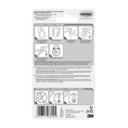 Command™ Koukku M, keskikokoinen, läpinäkyvä läpinäkyvillä nauhoilla (17091CLR) 3M Deutschland GmbH:sta sisältää pakkauksen takapuolen, jossa on monikielinen kuvallinen ohje, varoitukset ja 3M logo oikeassa alakulmassa.